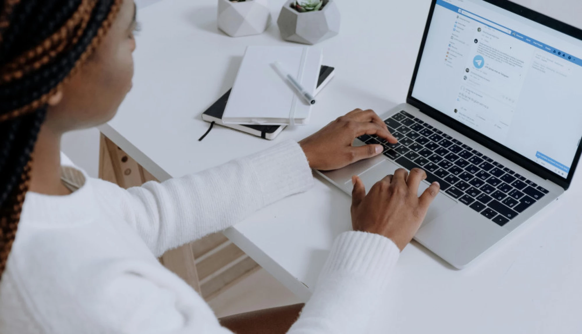 woman at a desk working on her laptop